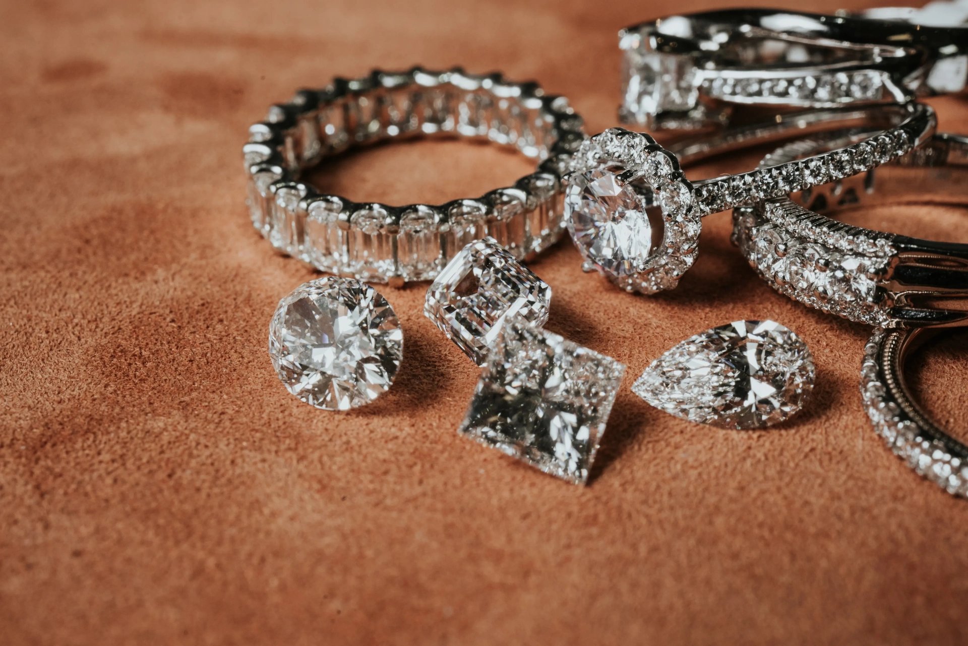 Diamond engagement rings, loose diamonds, and fine watches on suede - jewelry insurance Florida coverage from Insurance Specialists of SW Florida