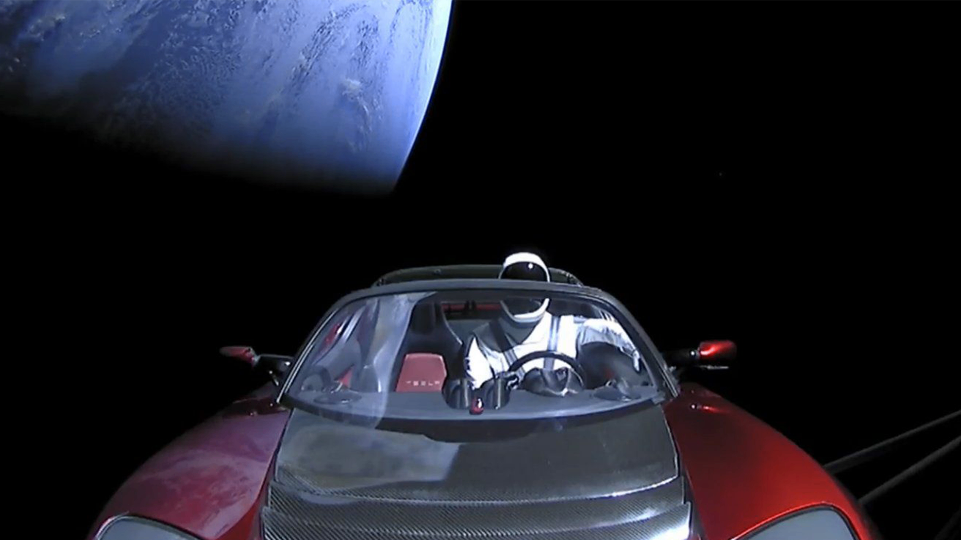 Tesla Roadster and Starman floating in orbit above Earth - space debris and homeowners insurance coverage explained by Insurance Specialists of SW Florida